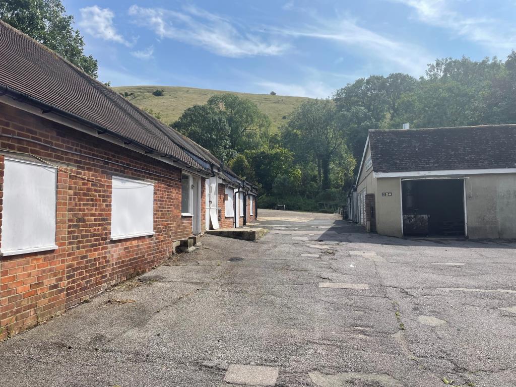 Lot: 8 - FREEHOLD COMMERCIAL OPPORTUNITY WITH POTENTIAL IN FAVOURED SOUTH DOWNS LOCATION - Yard with view of Downs and outbuildings